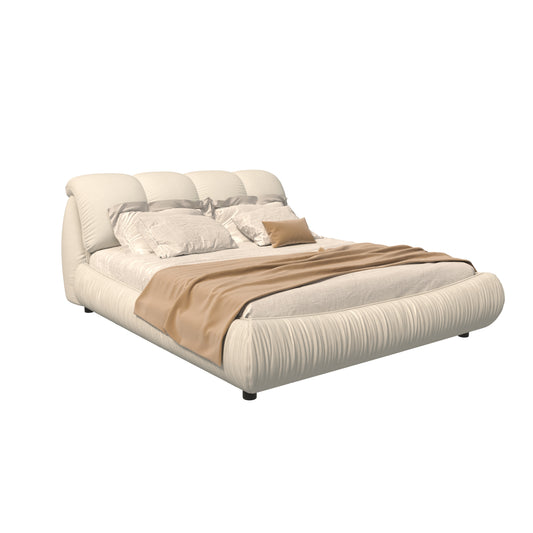 Modern cream upholstered bed frame with plush tufted headboard and tan throw