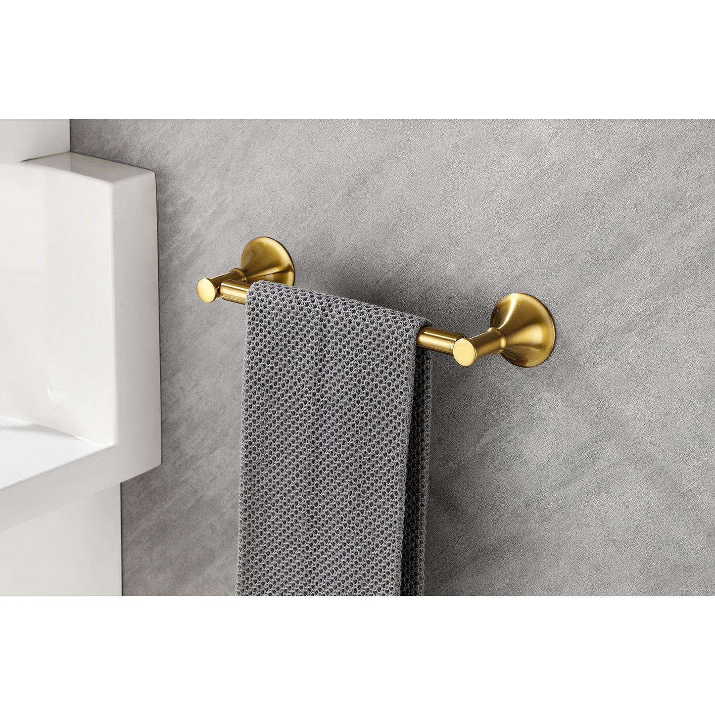 Brushed brass towel bar with textured gray towel modern bathroom fixture