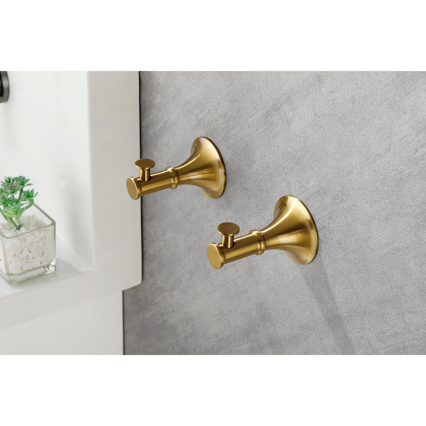 Pair of brushed brass wallmounted toilet paper holders with traditional styling