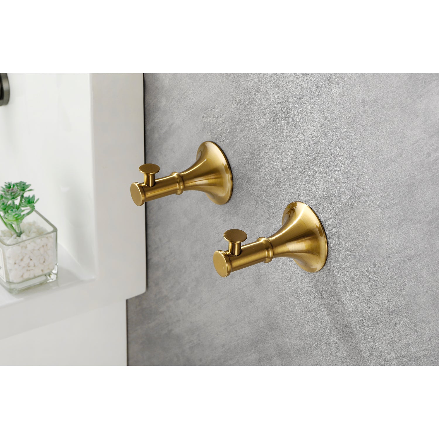 Pair of brushed brass wallmounted toilet paper holders with traditional styling