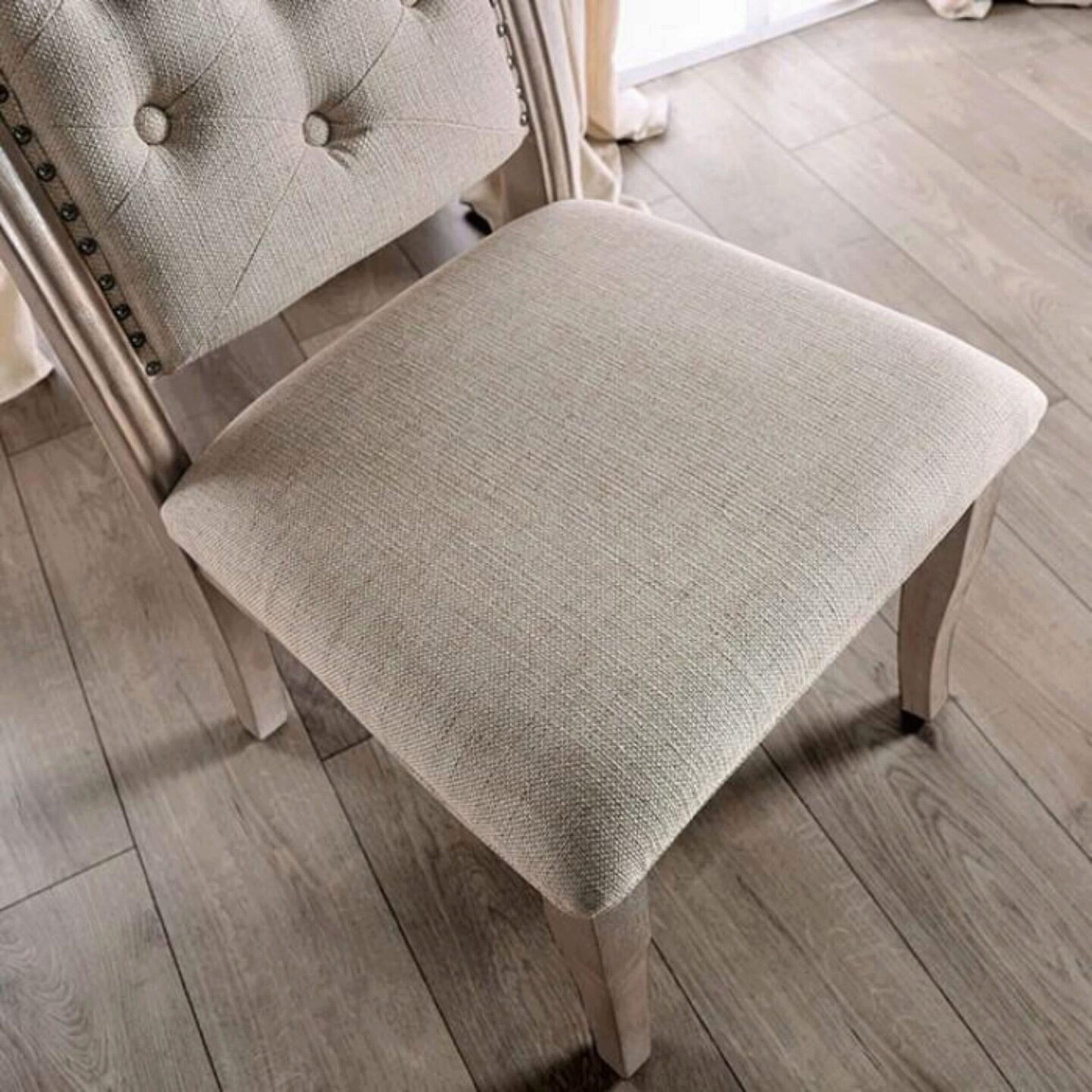 Beige linen tufted dining chair with nailhead trim