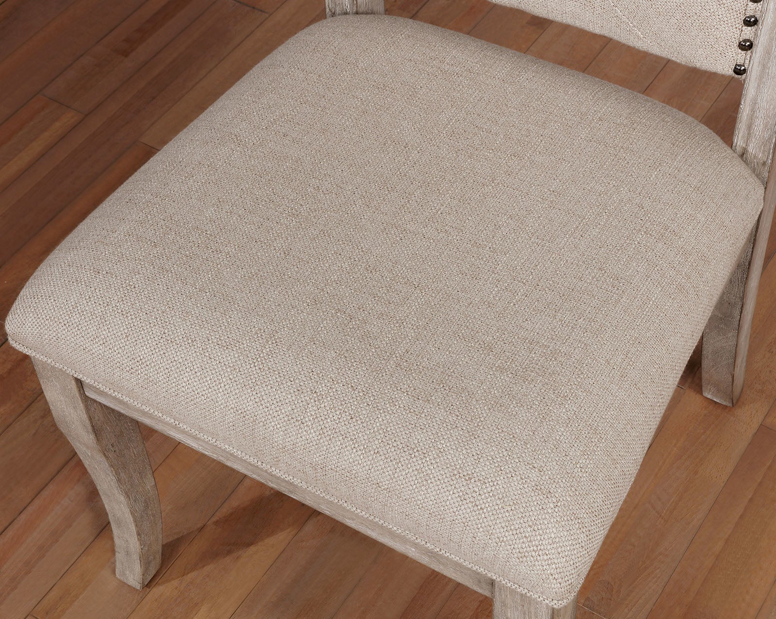 Beige upholstered dining chair seat with distressed wood legs