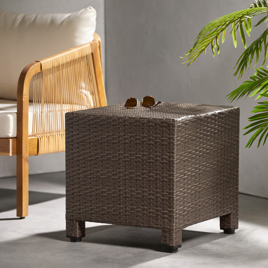 Dark brown woven resin wicker cube ottoman with sunglasses on top