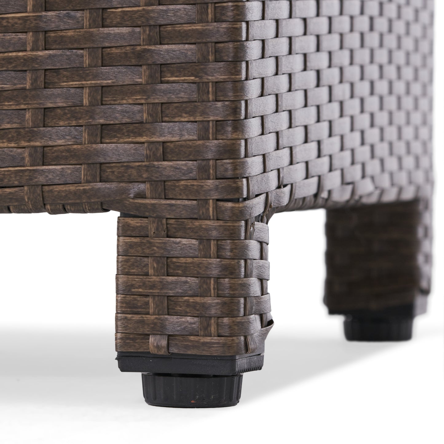 Closeup of dark brown woven wicker furniture legs with adjustable black feet