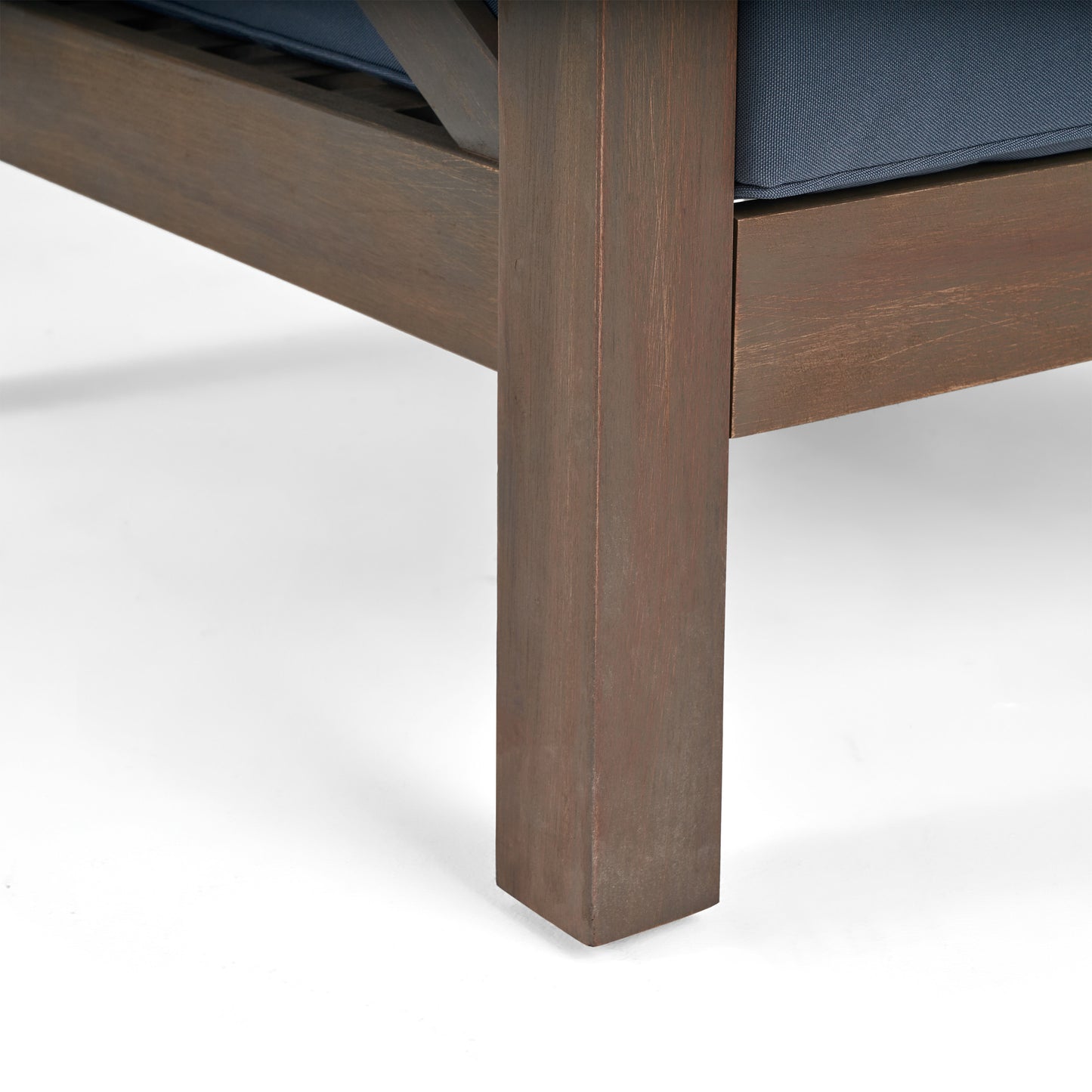 Dark brown wood armchair leg with visible grain texture