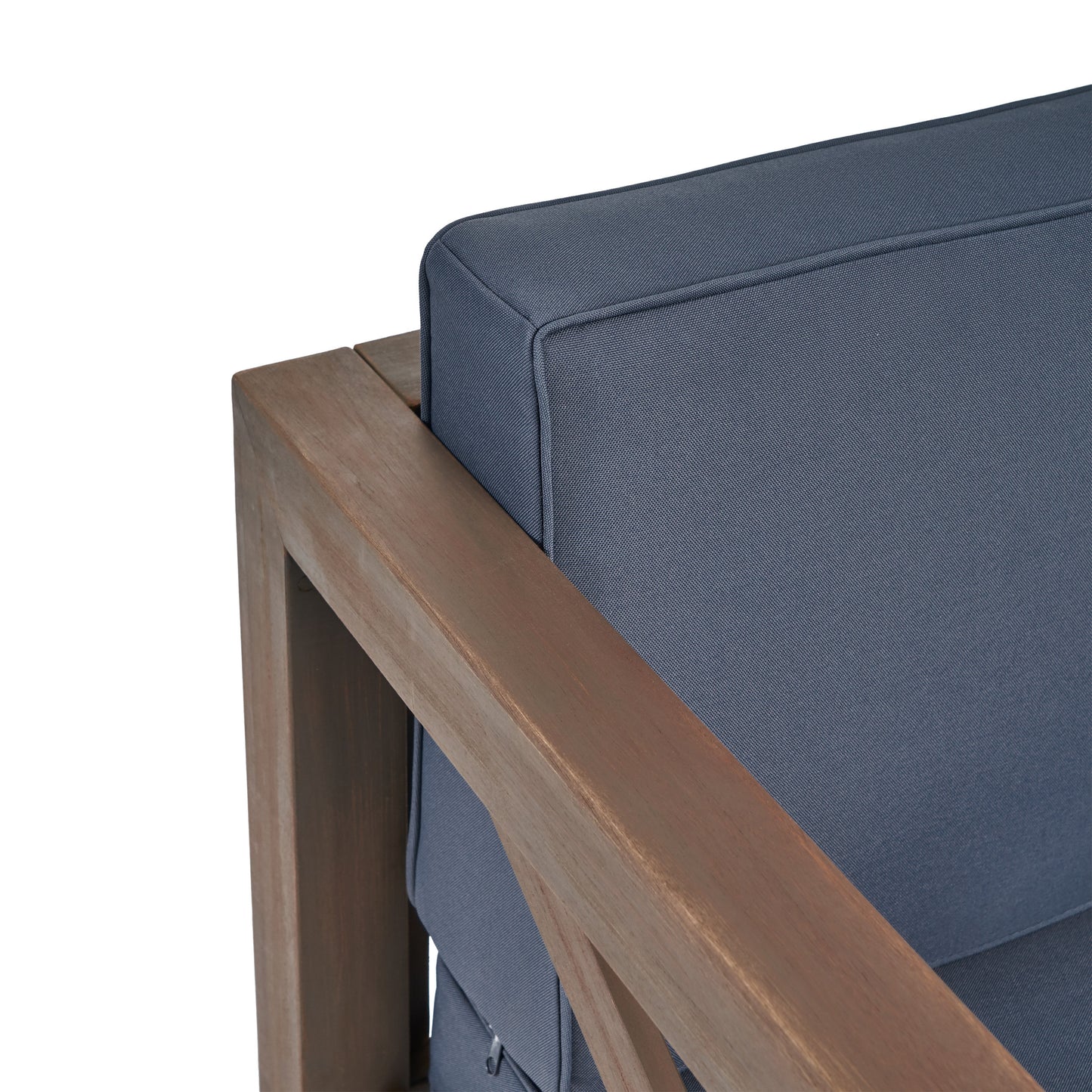 Closeup of a dark blue cushion on a wooden armchair emphasizing outdoor furniture comfort