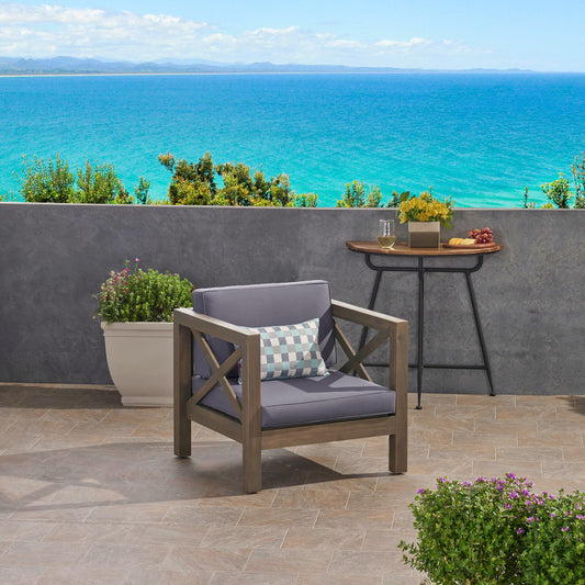 Dark grey upholstered armchair with Xframe wood legs perfect for patio relaxation