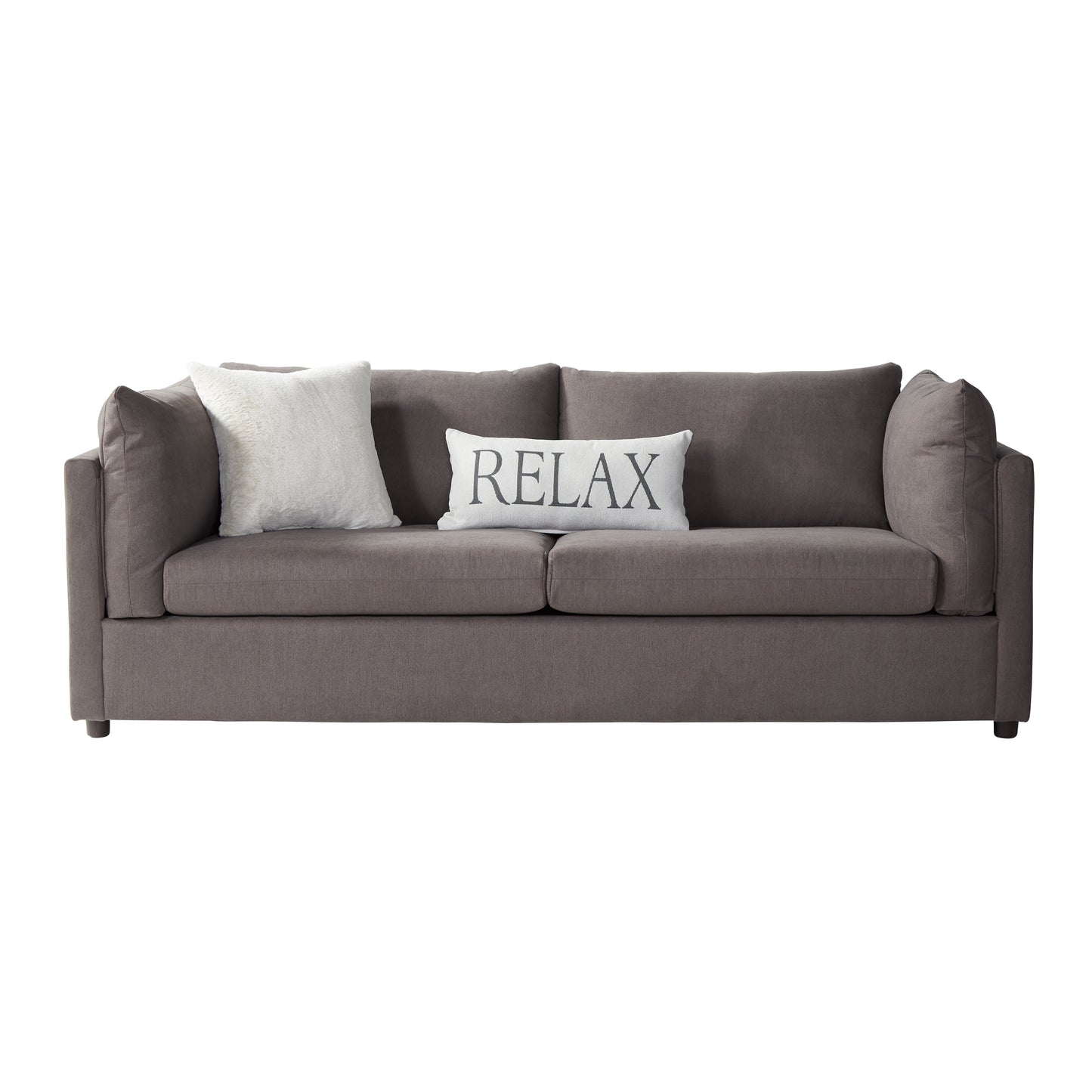 A modern comfortable taupe sofa with two plush cushions one white faux fur and one white with black text reading RELAX