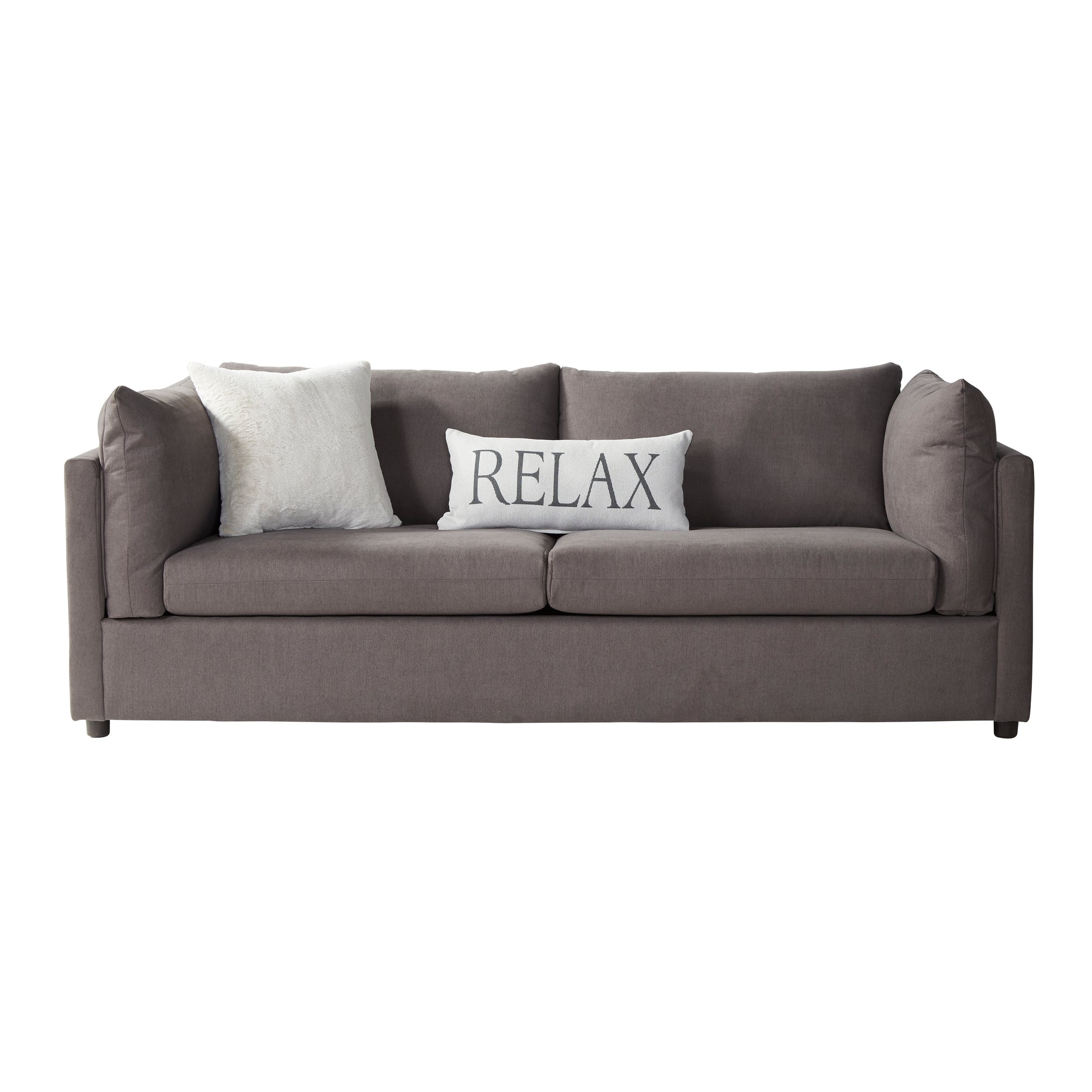 A modern comfortable taupe sofa with two plush cushions one white faux fur and one white with black text reading RELAX