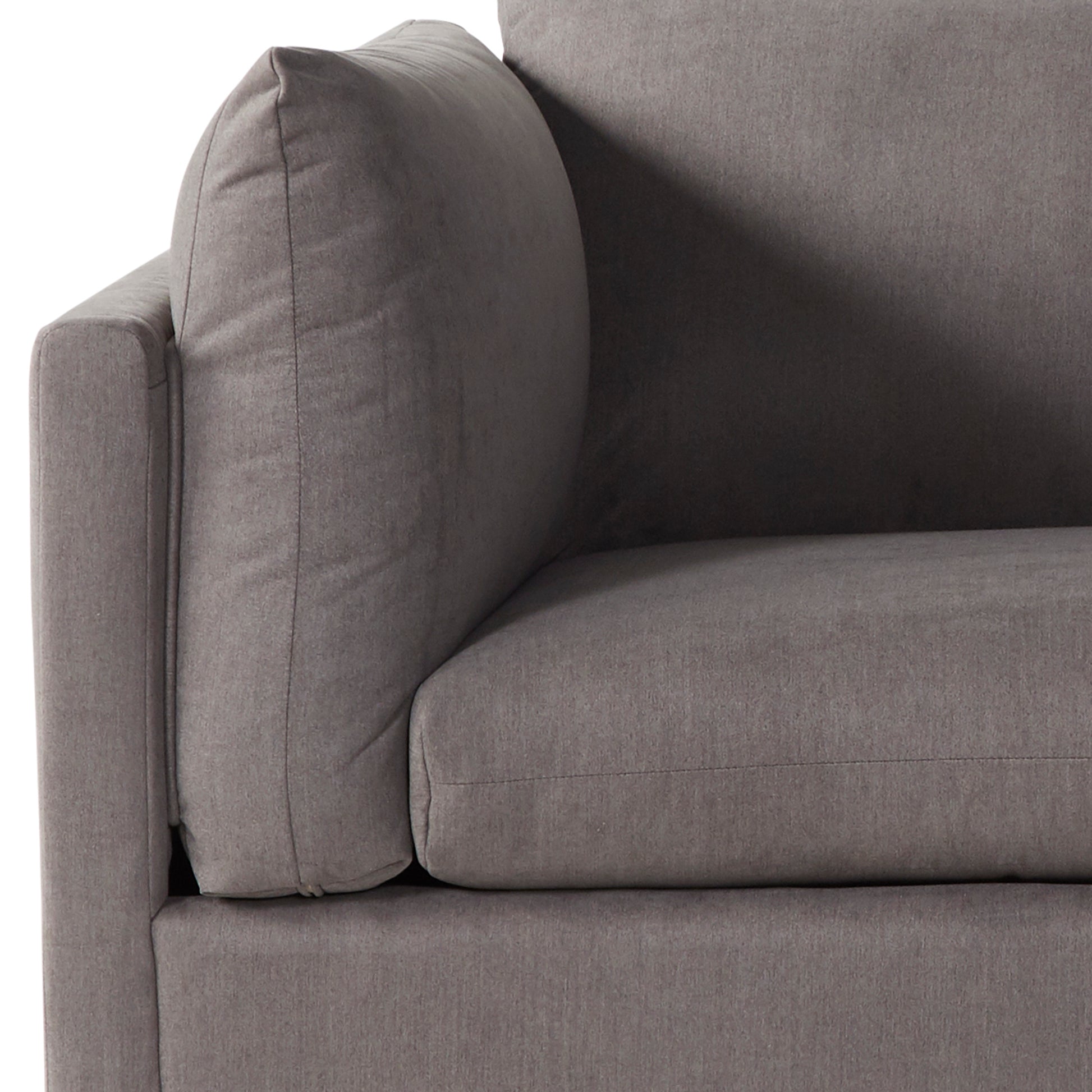 Closeup of a plush grey fabric sofa armrest with textured detail