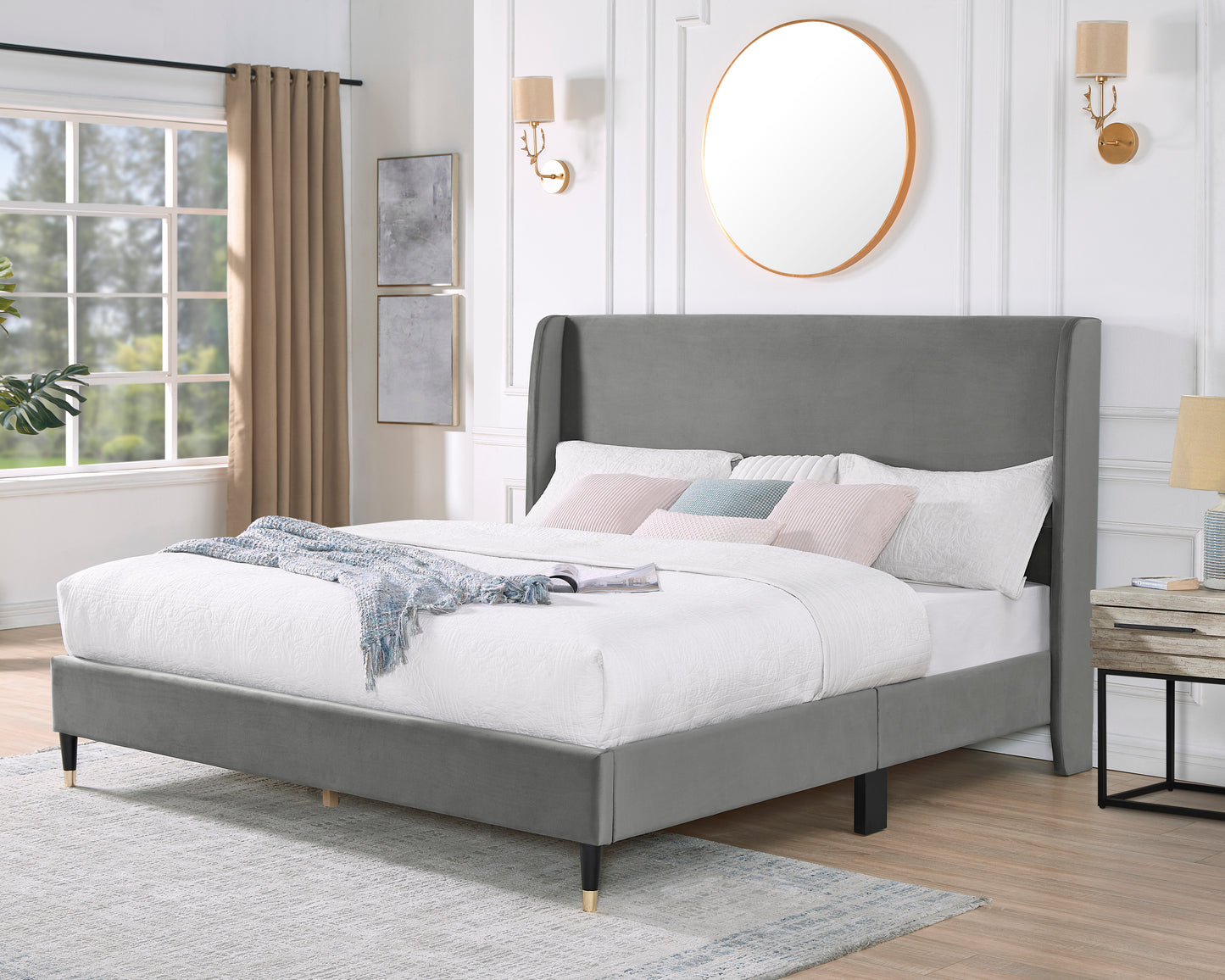 Gray velvet wingback bed frame with plush bedding and decorative pillows