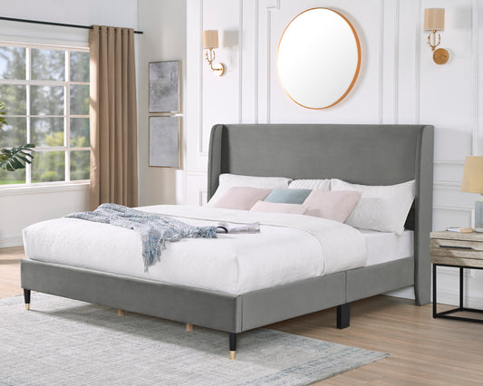 Contemporary grey velvet wingback bed with goldtipped legs and white bedding