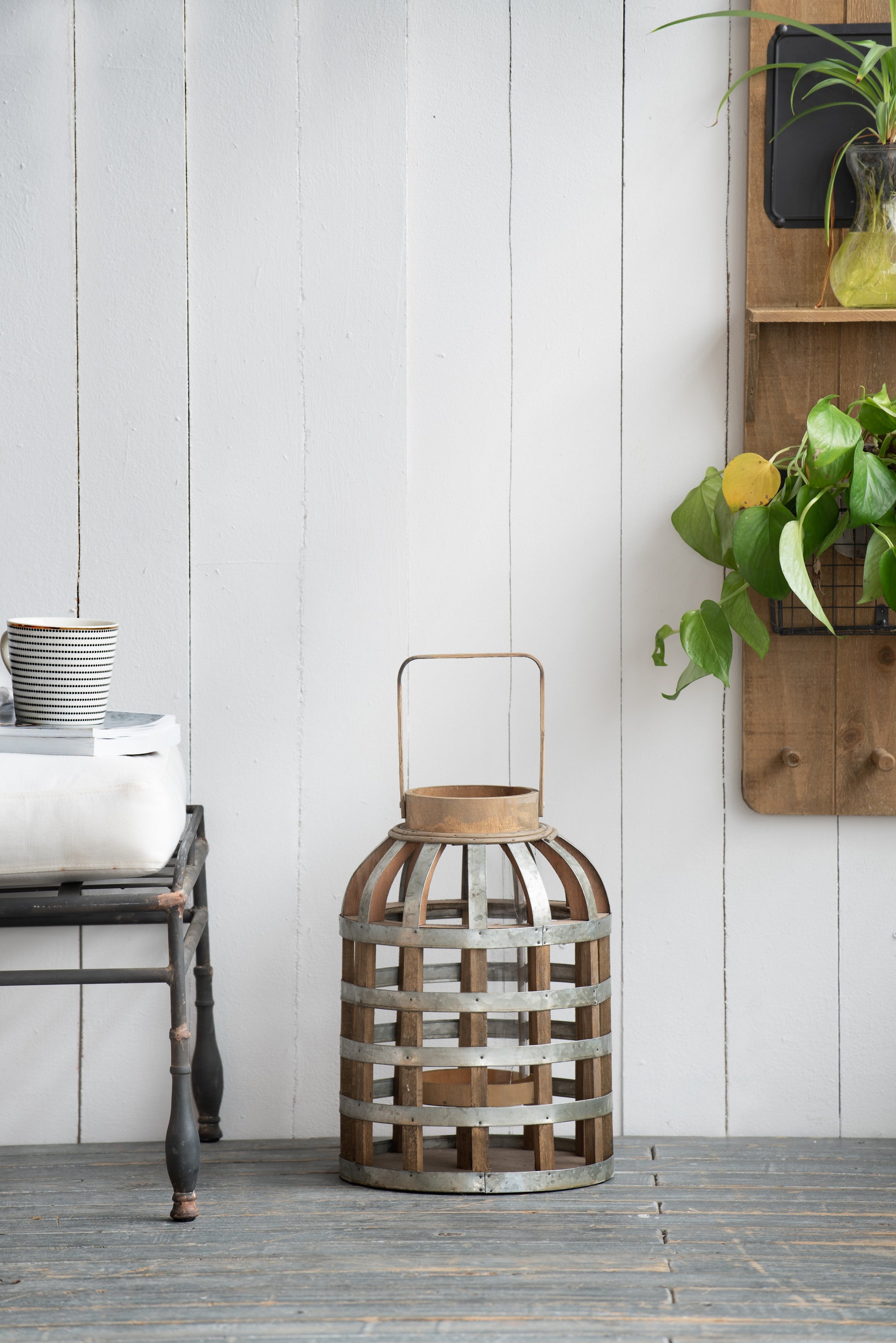 Rustic wooden and metal lantern with a cylindrical design perfect for home decor