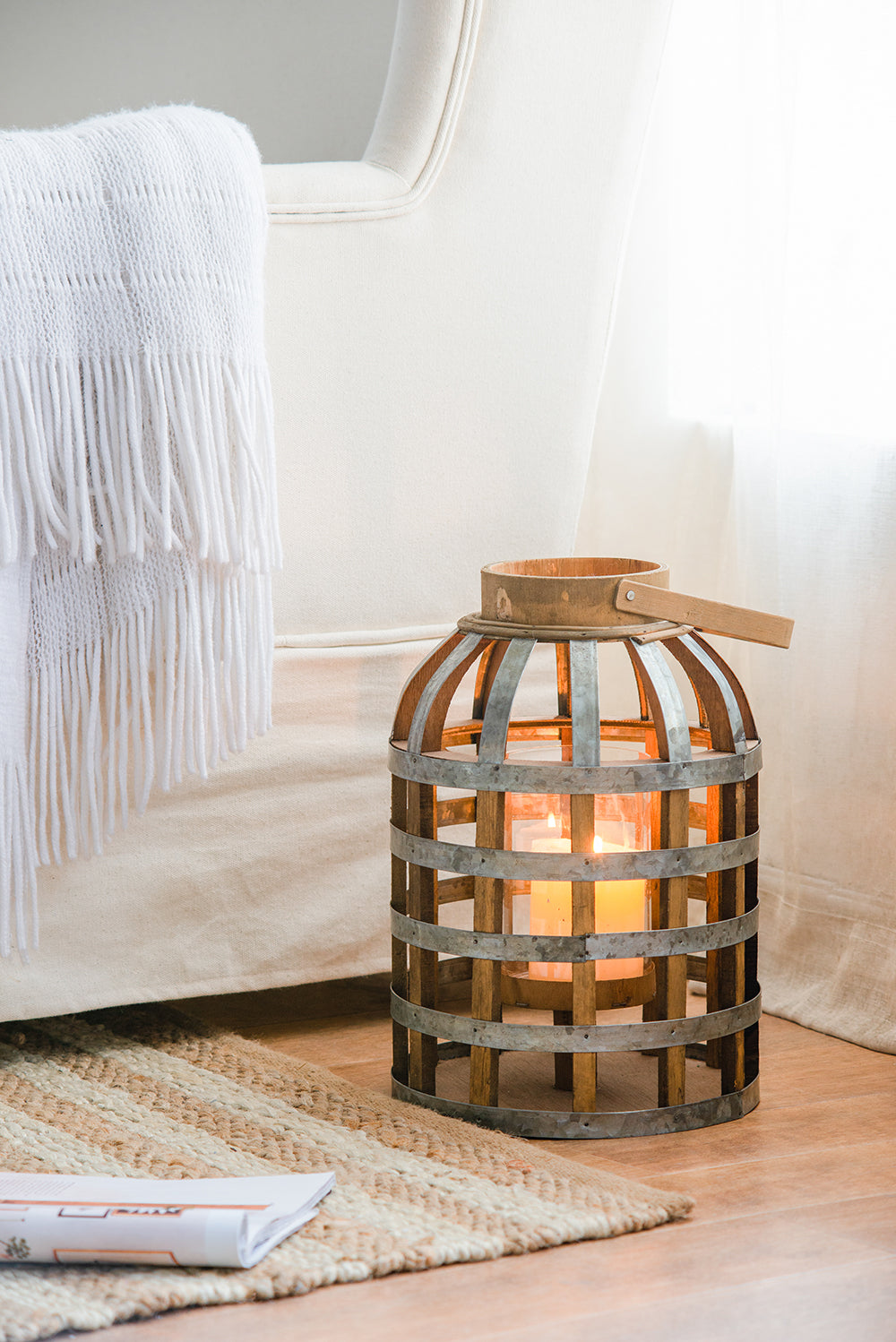 Rustic wooden and metal lantern with burning candles adding cozy ambiance to any room
