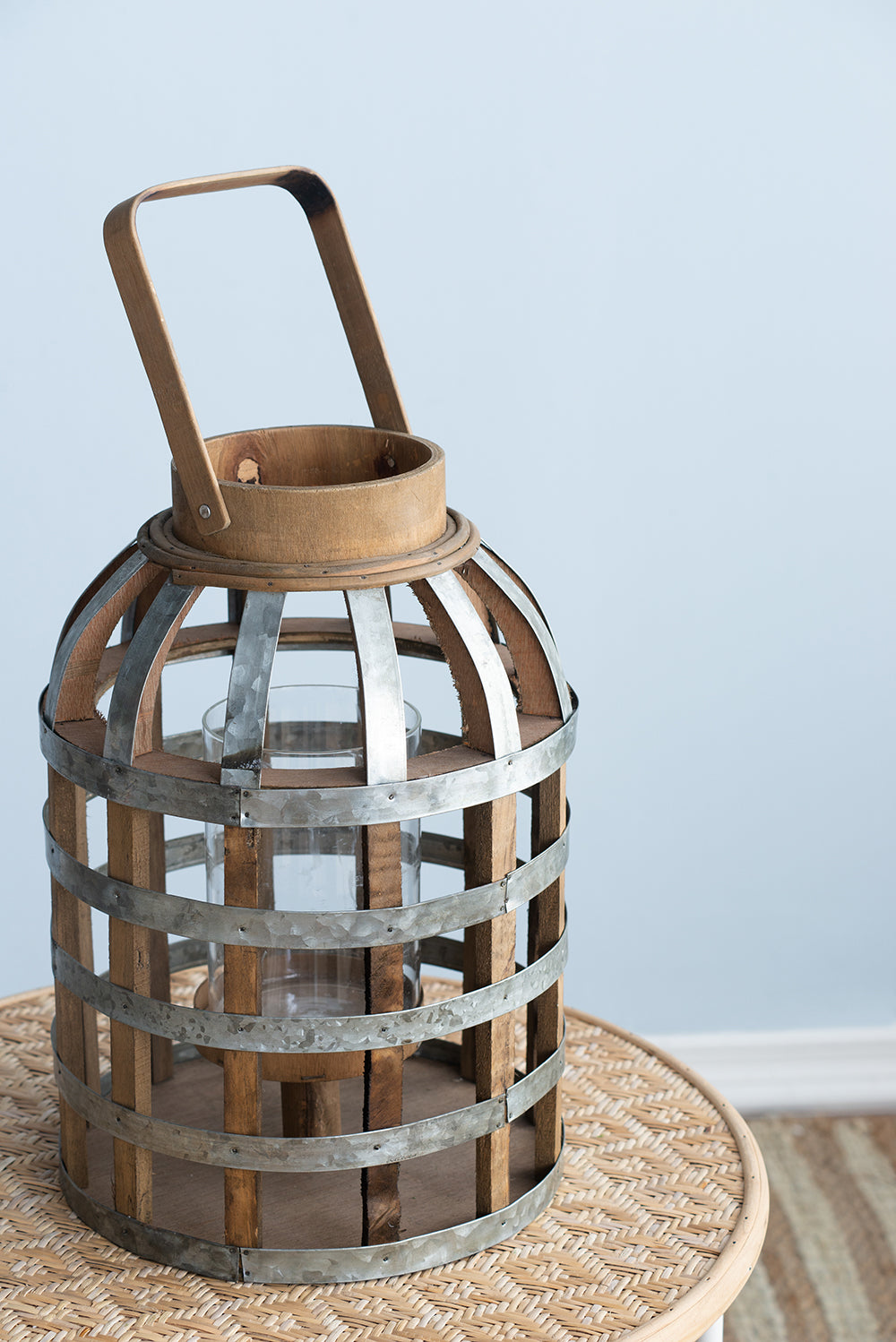 Rustic wood and metal lantern with glass cylinder centerpiece