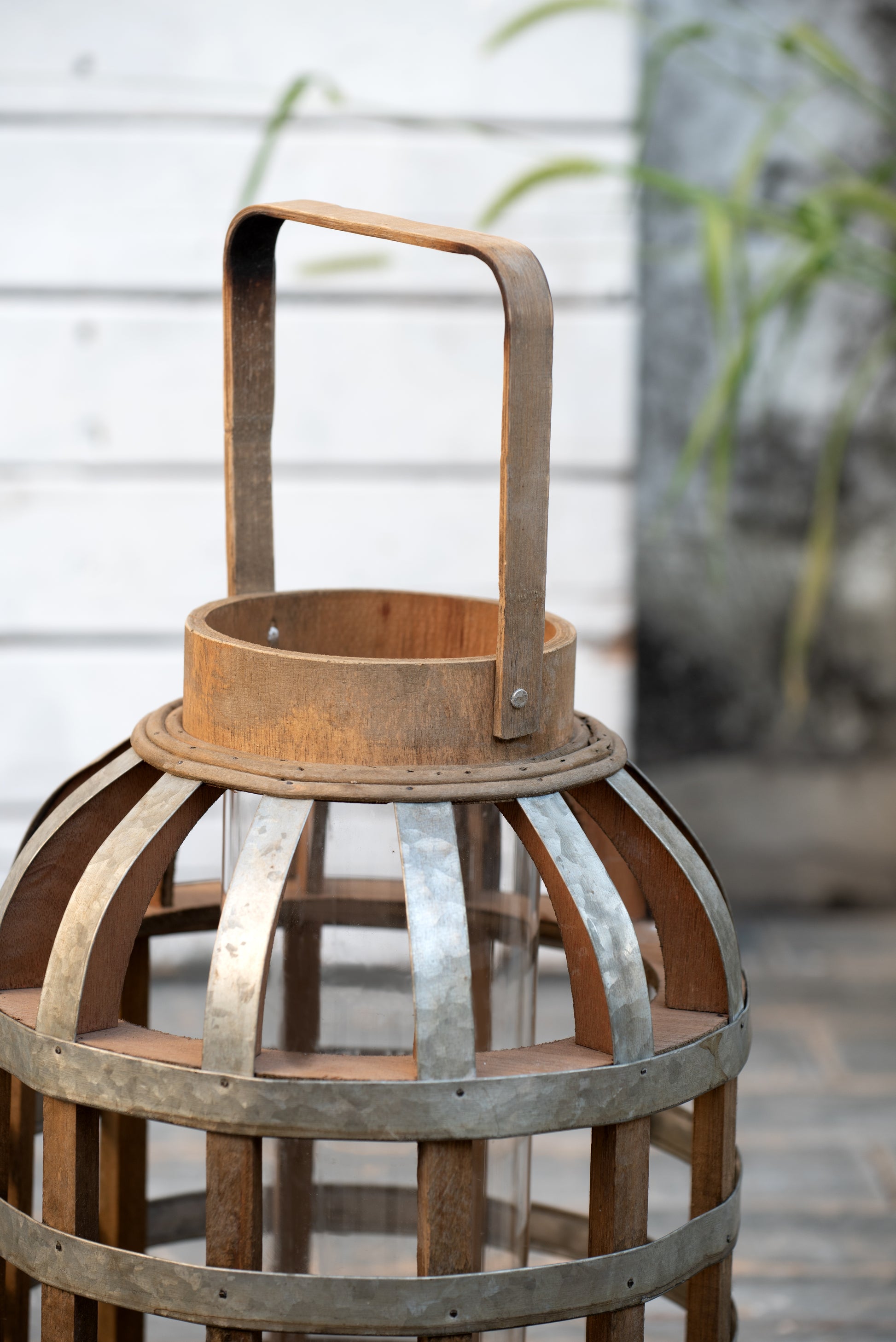 Rustic wooden lantern with metal accents perfect for outdoor patio decor