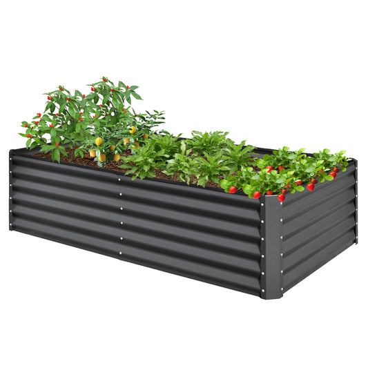 Galvanized steel raised garden bed in dark gray with young tomato and pepper plants