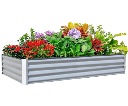 Galvanized steel raised garden bed filled with vibrant red flowers hydrangeas and colorful croton leaves