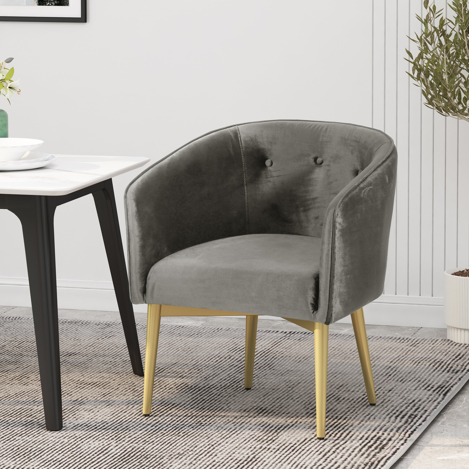 Comfortable grey velvet accent chair with elegant gold metal legs perfect for a modern living room