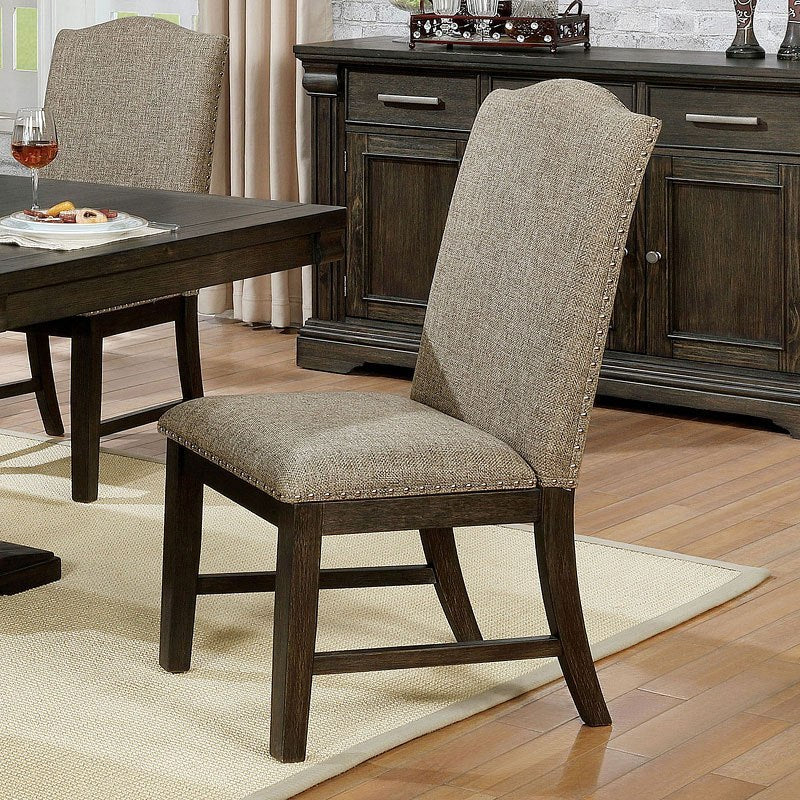 Upholstered dining chair with nailhead trim and dark wood legs
