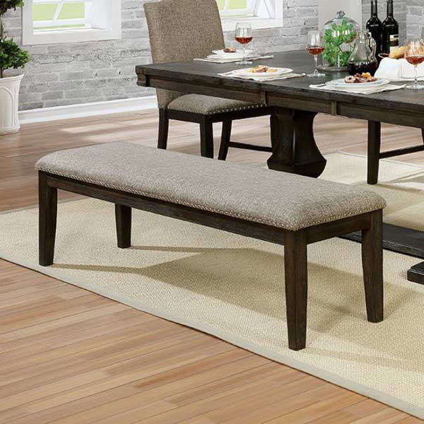 Upholstered dining bench with dark wood legs and nailhead trim