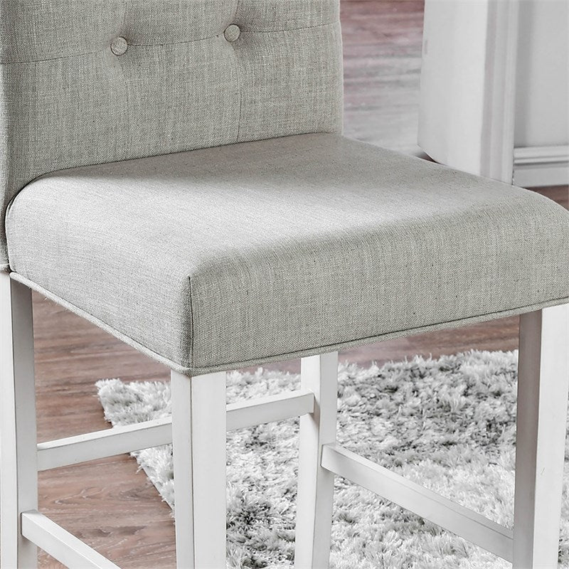 Light gray linen upholstered bar stool with button tufted back and white wooden legs