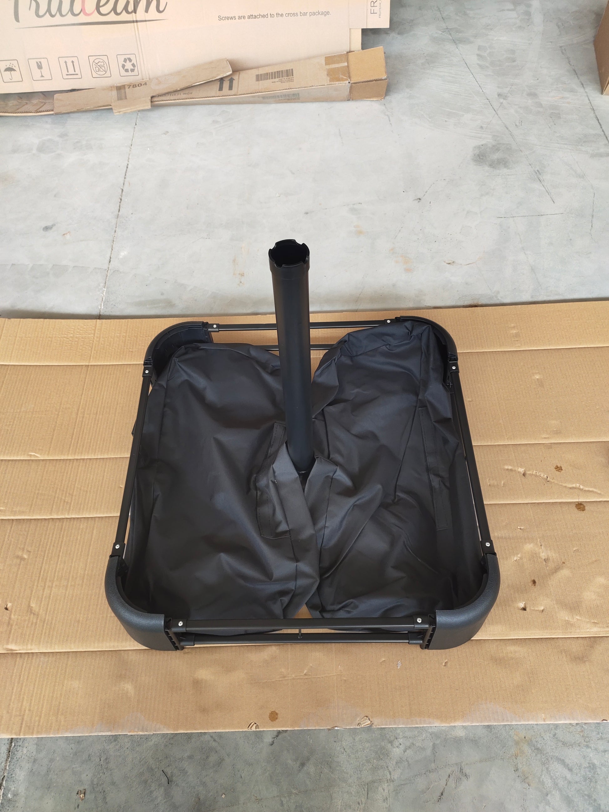 Black patio umbrella base stand with adjustable pole holder