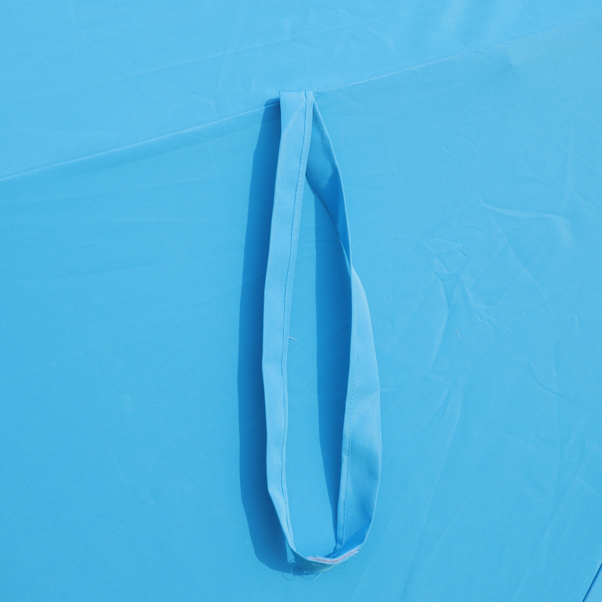 Blue fabric tote bag with reinforced stitching on strap