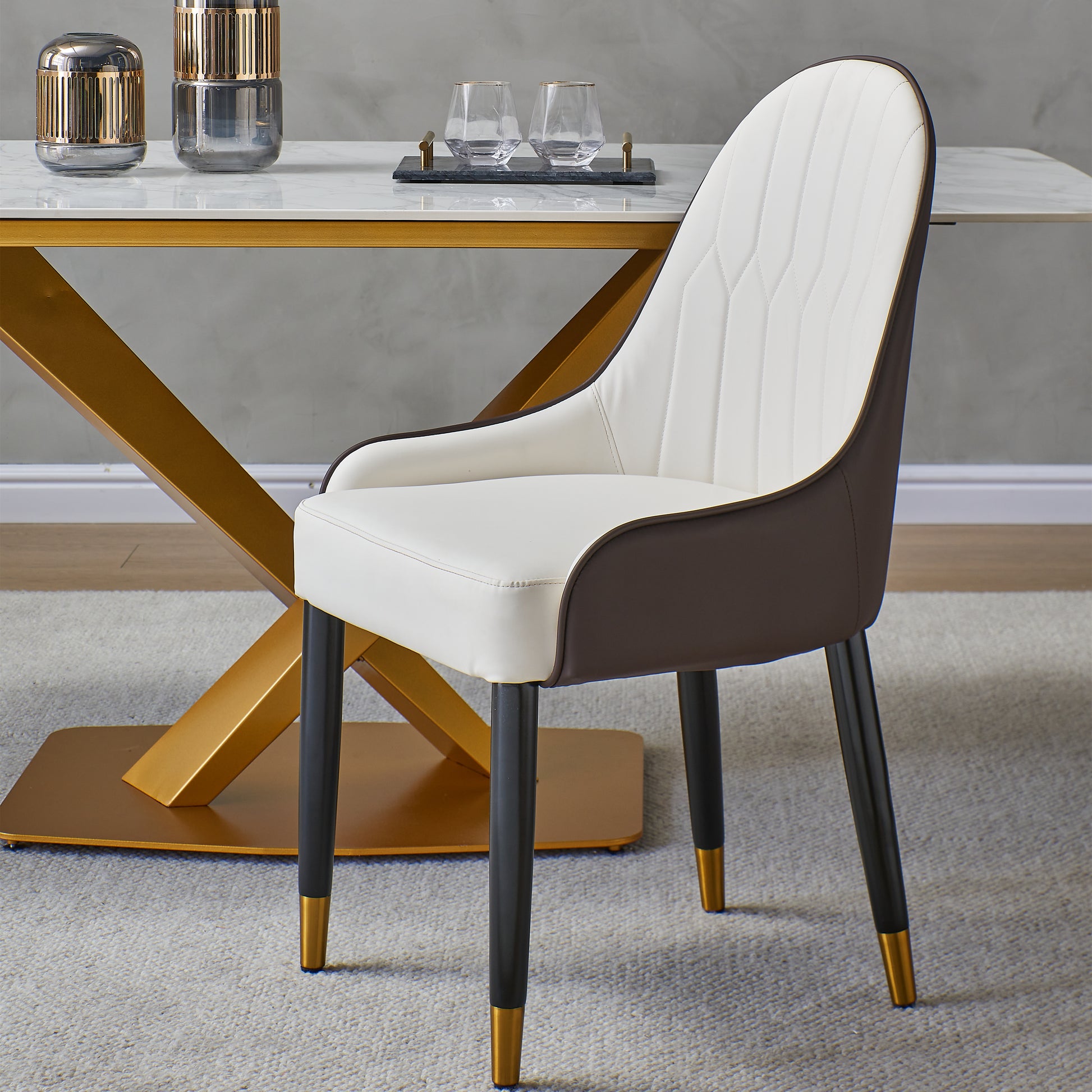 Cream and brown leather dining chair with gold accents tufted back detail and tapered legs