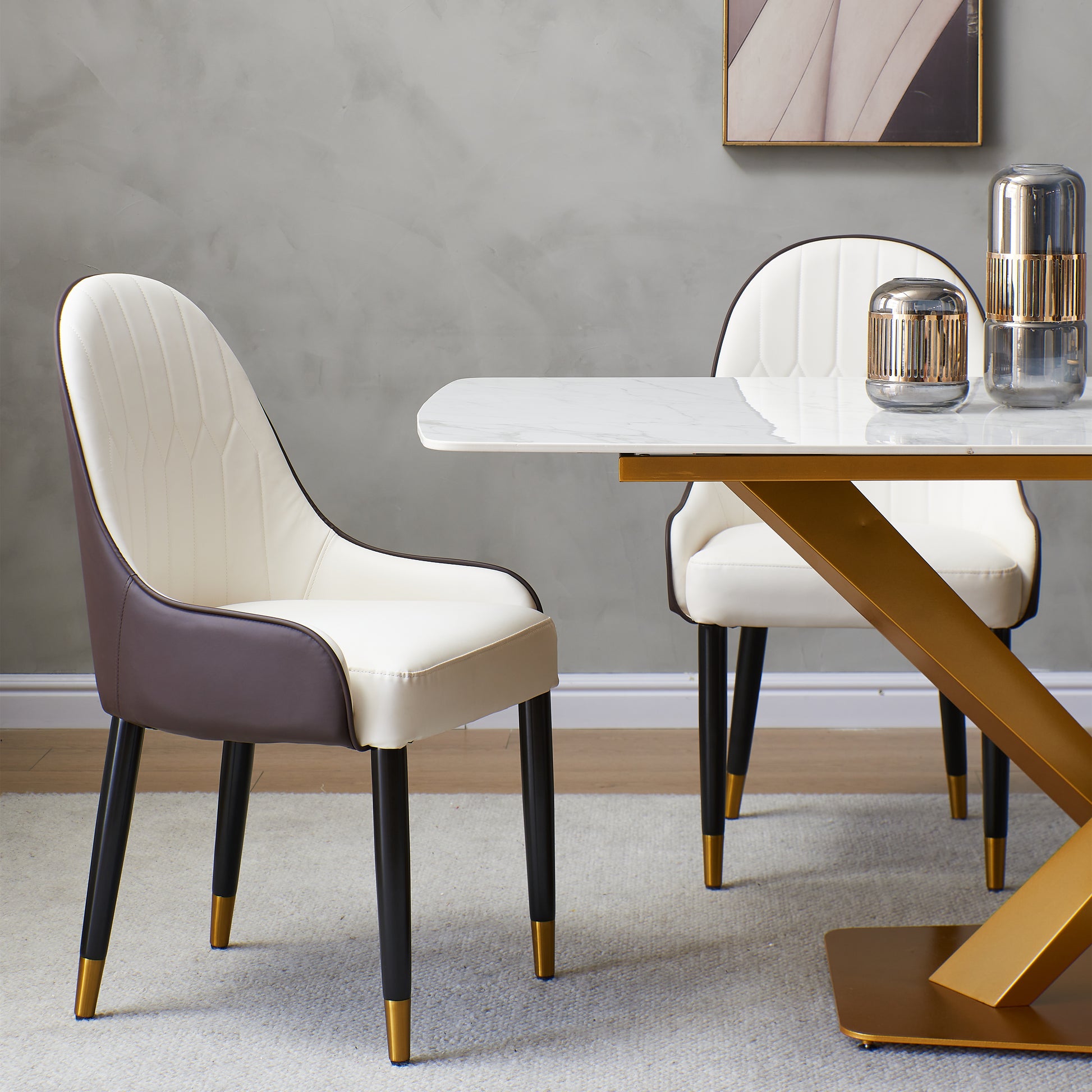 Cream and brown upholstered dining chairs with diamond stitching and goldtipped legs