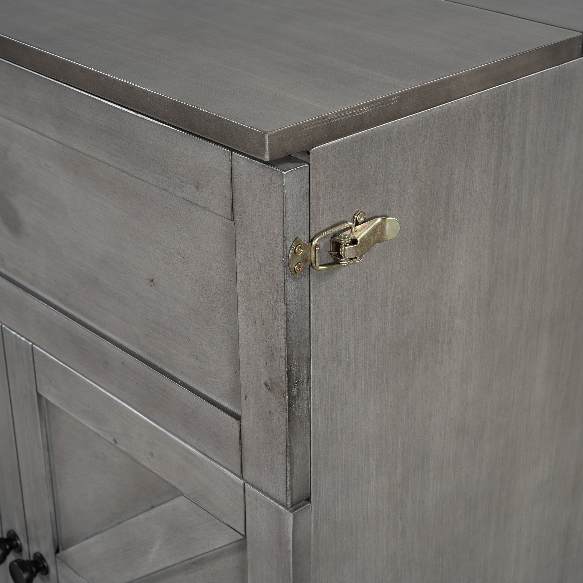 Grey wooden cabinet with metallic latch and ornate drawer pulls