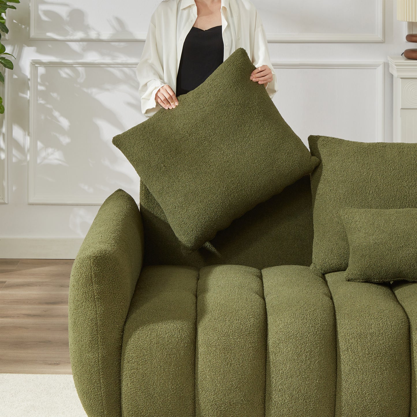 Green textured boucle pillow adding warmth and comfort to a modern sofa