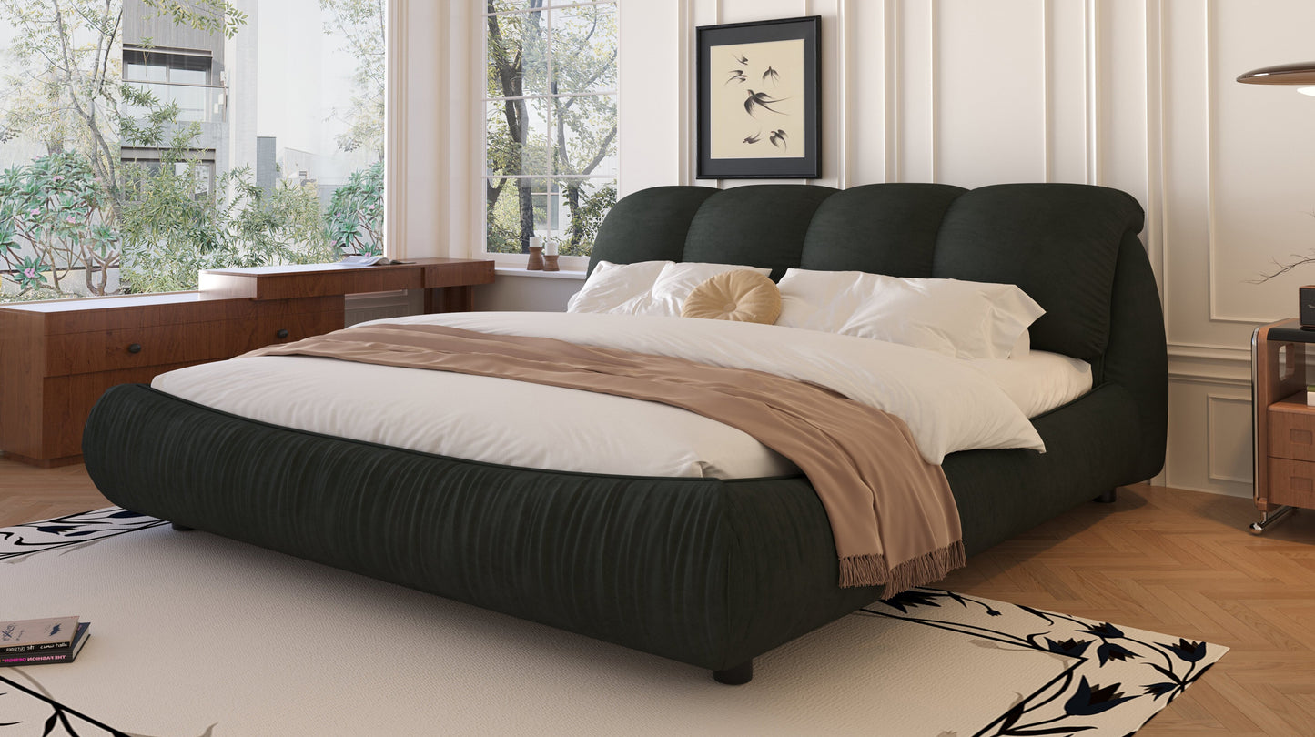 Modern dark green upholstered king bed with fluted design and taupe throw