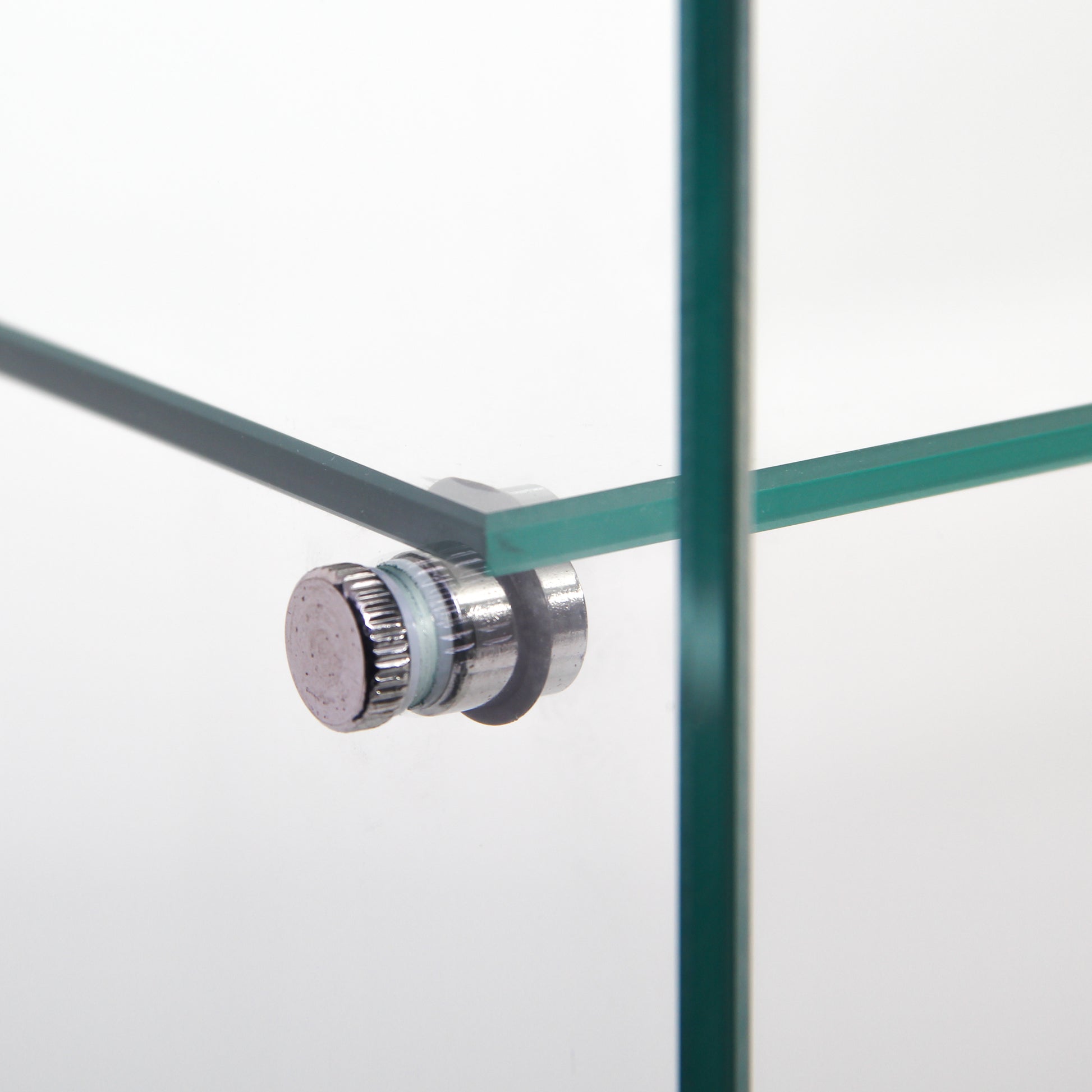 Closeup of a chrome shelf support knob on a tempered glass shelf
