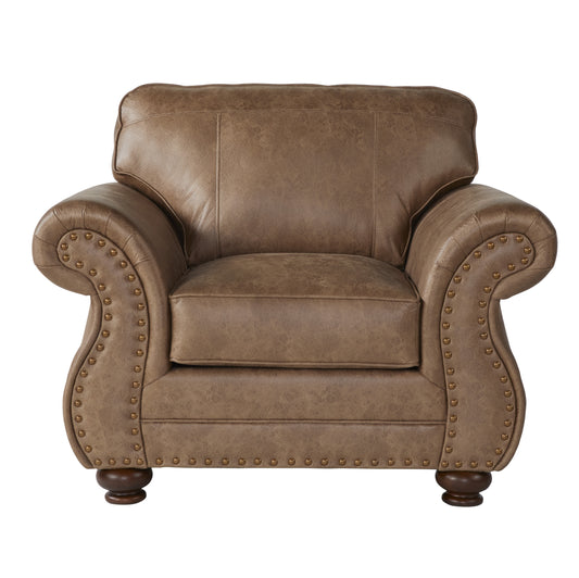 Tan leather accent chair with brass nailhead trim and turned wood legs