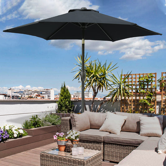 Black patio umbrella with crank mechanism providing shade on a rooftop terrace
