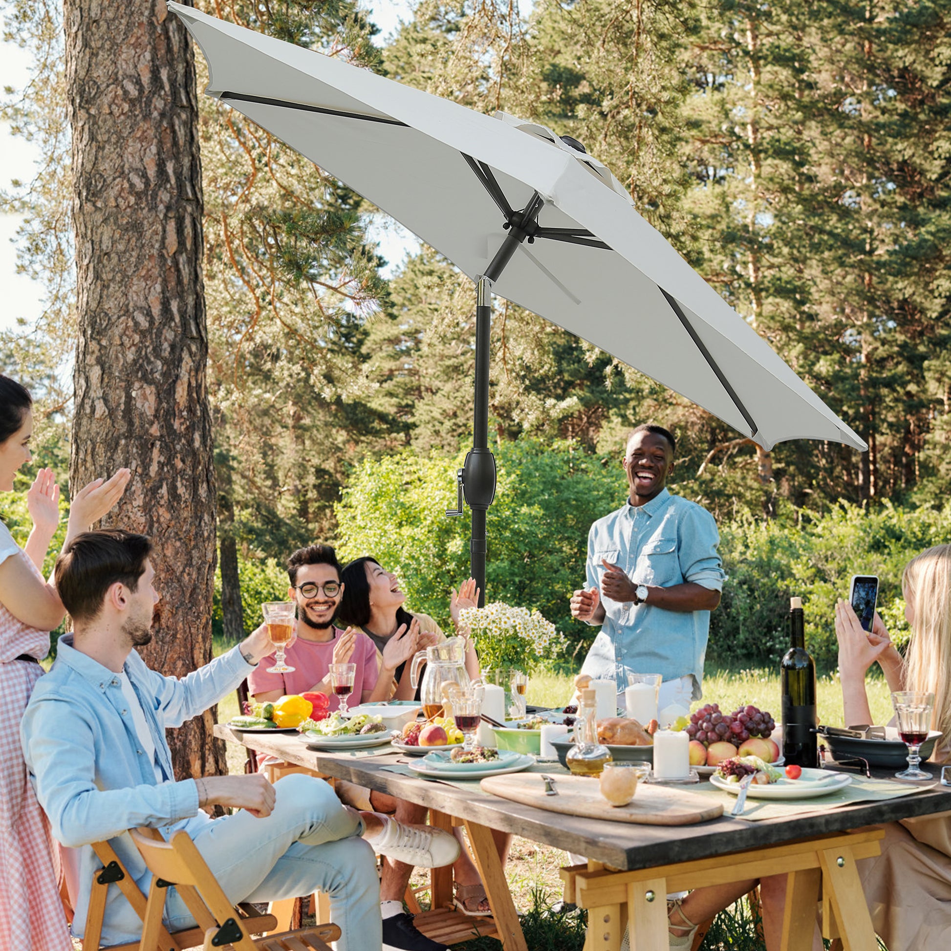 White rectangular patio umbrella providing shade for an outdoor dining party