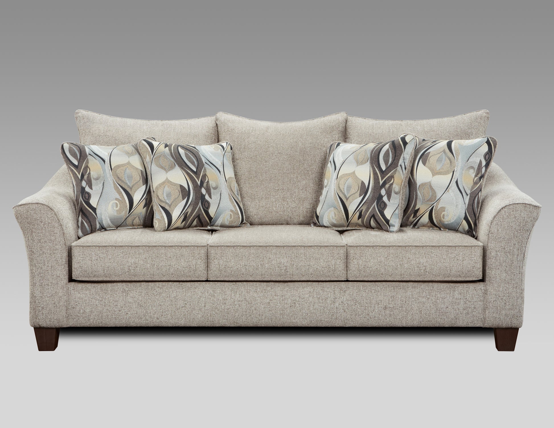 Neutral textured fabric sofa with four abstract patterned accent pillows