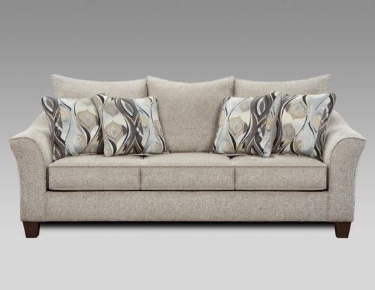 Neutral textured fabric sofa with four abstract patterned accent pillows
