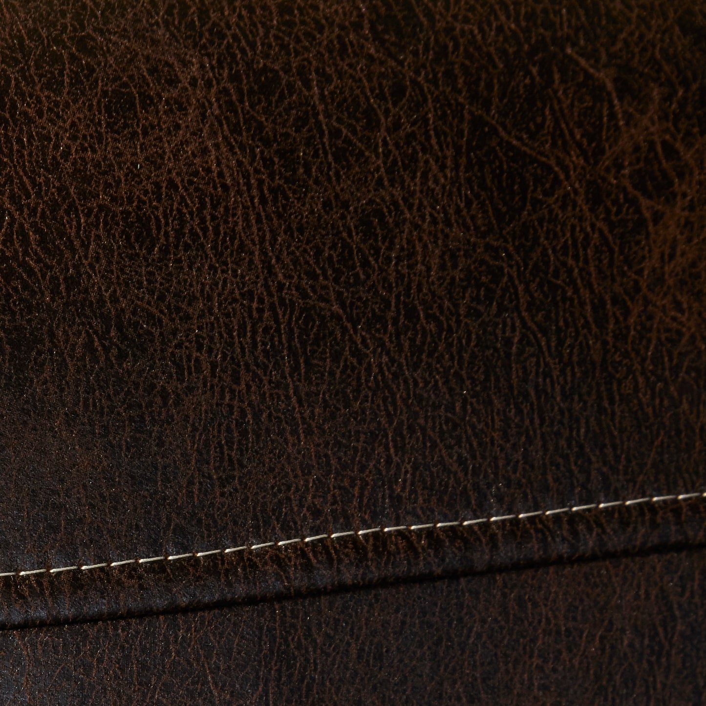 Rich dark brown textured leather with visible grain and white stitching detail