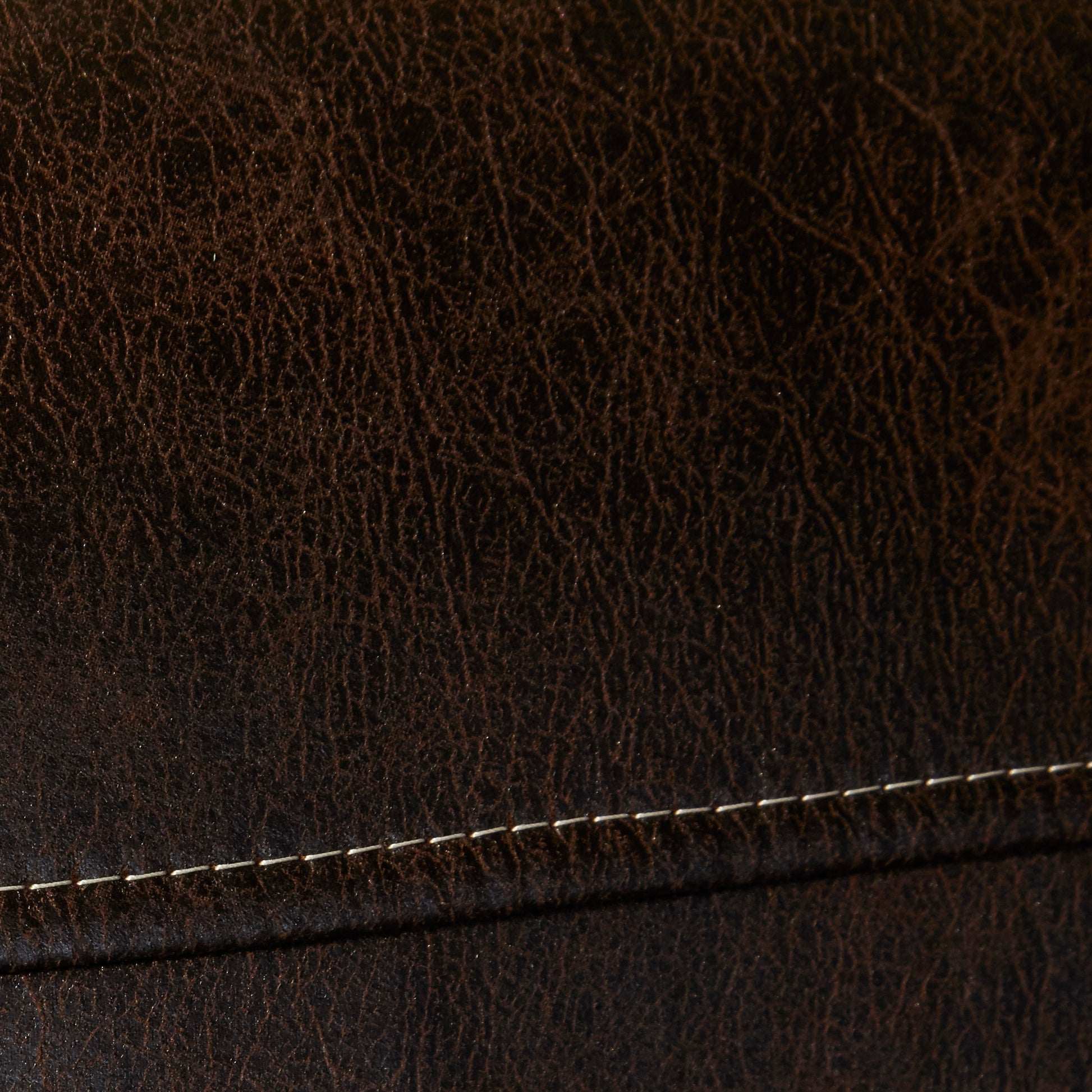 Rich dark brown textured leather with visible grain and white stitching detail