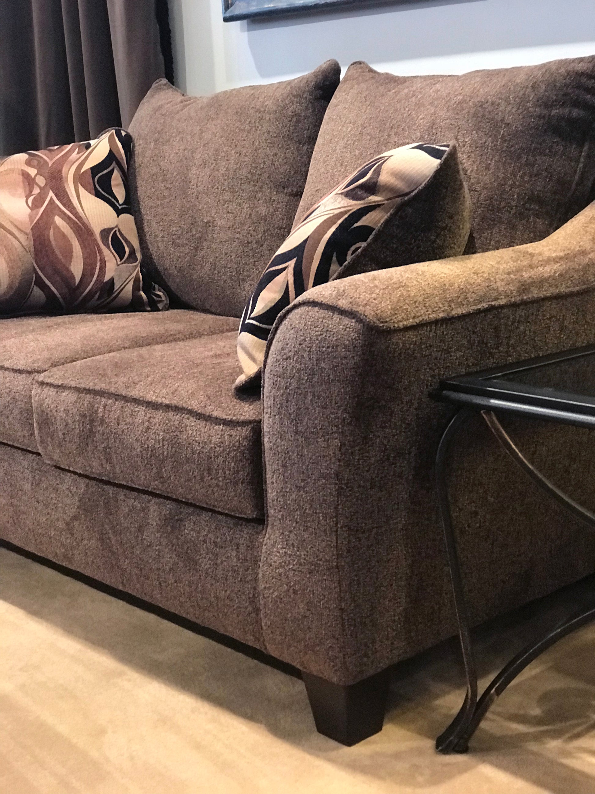 Brown textured fabric sofa with patterned throw pillows for living room comfort