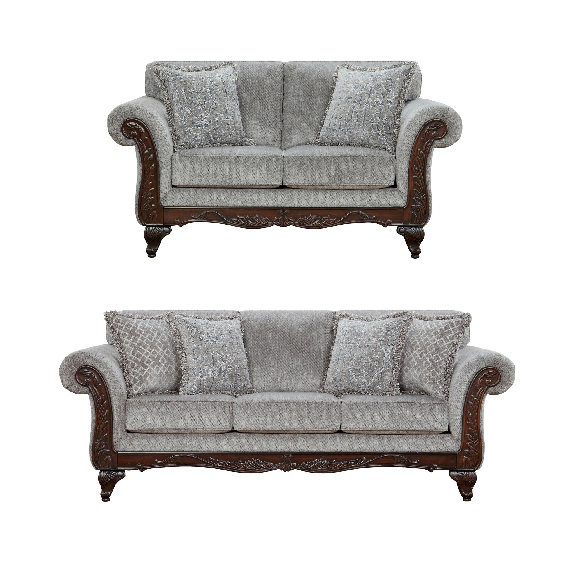 Elegant grey fabric loveseat with ornate dark wood trim and patterned throw pillows