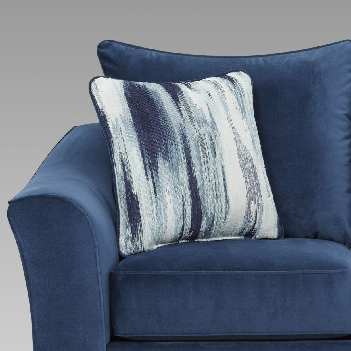 Blue velvet sofa with abstract pattern throw pillow