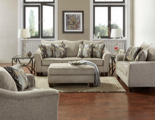 Comfortable gray fabric sofa with decorative pillows and matching ottoman