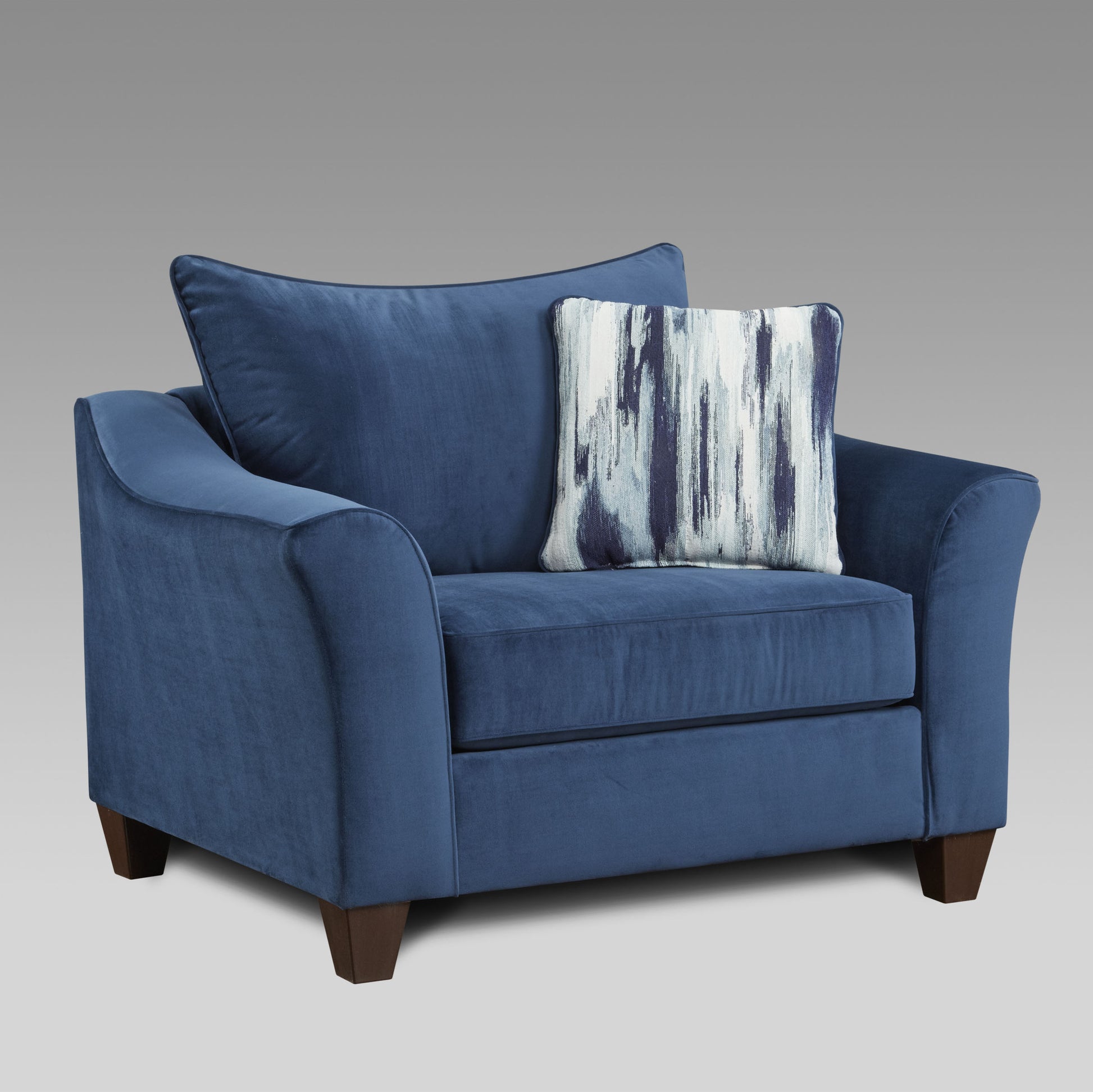 Plush navy blue velvet armchair with a decorative abstract pattern pillow for modern living spaces
