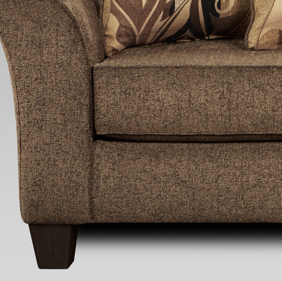 Brown textured fabric sofa detail with decorative throw pillows
