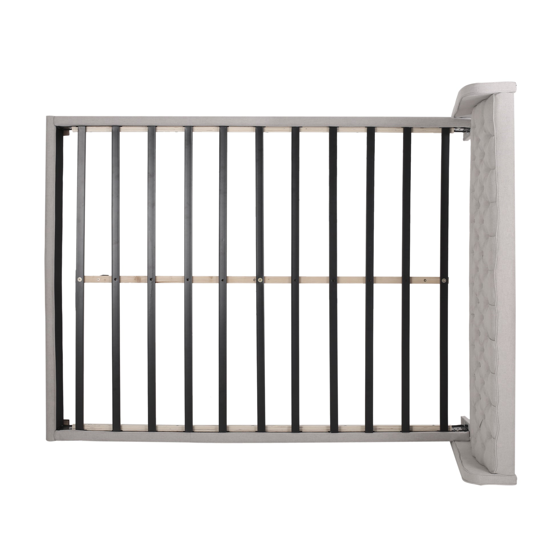 Grey upholstered tufted headboard with a metal slat bed frame showing support structure