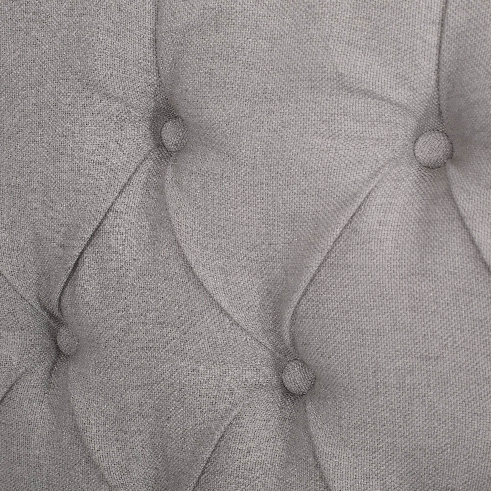 Closeup of grey linen tufted upholstery fabric detail with visible weave