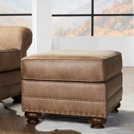 Tufted brown leather ottoman with nailhead trim and dark wood legs perfect for a living room accent